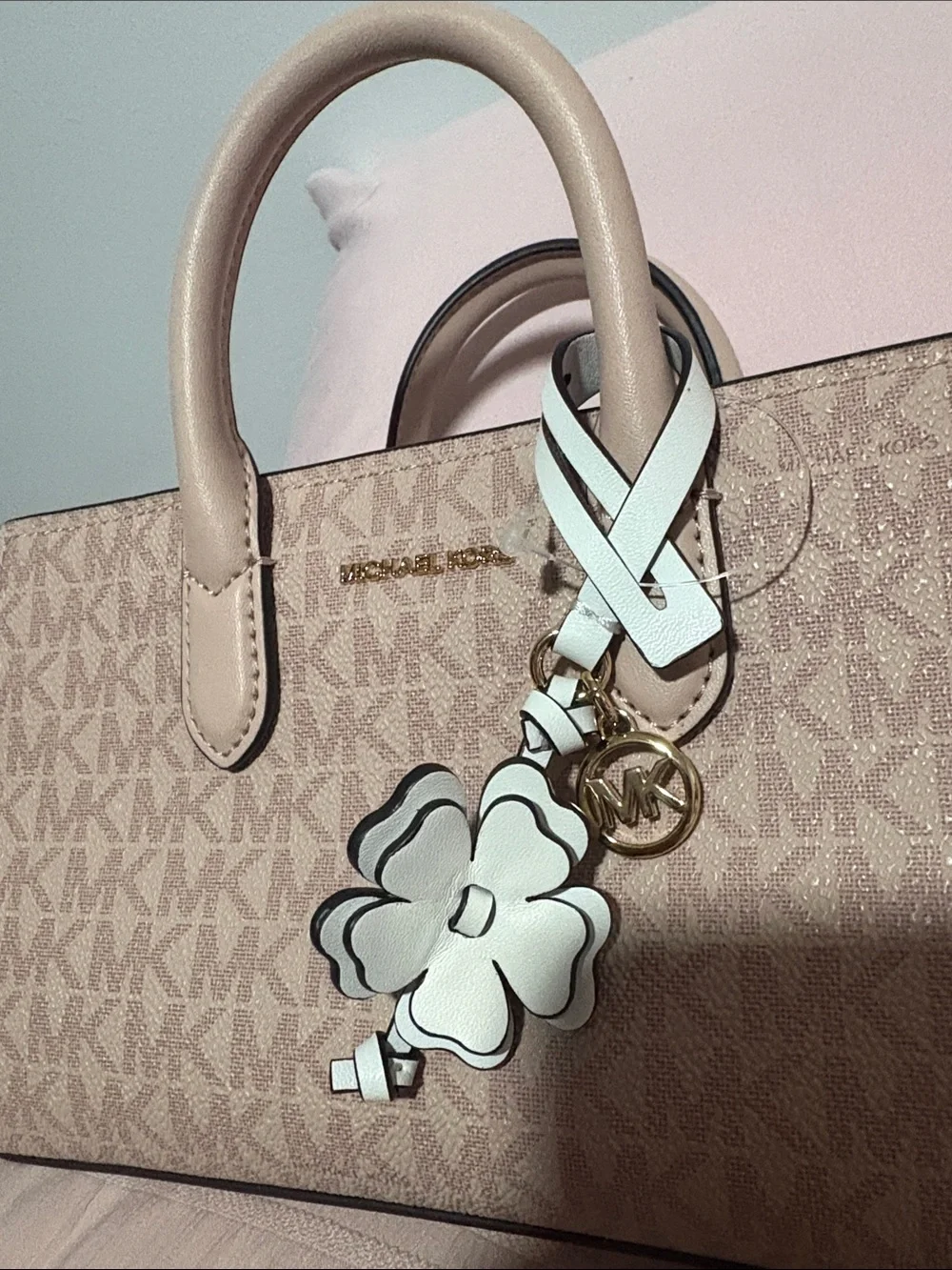 A cute MICHAEL KORS Blush Pink Logo Satchel with Floral Charm